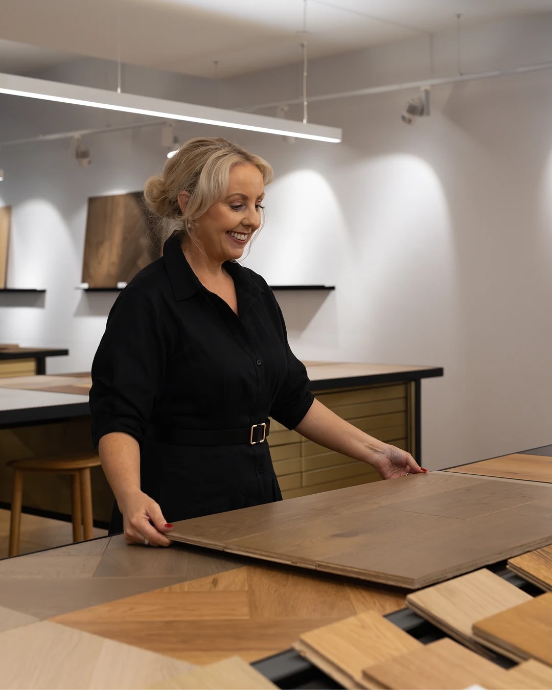 Sydney showroom manager, Olivia, showing a timber flooring panel.
